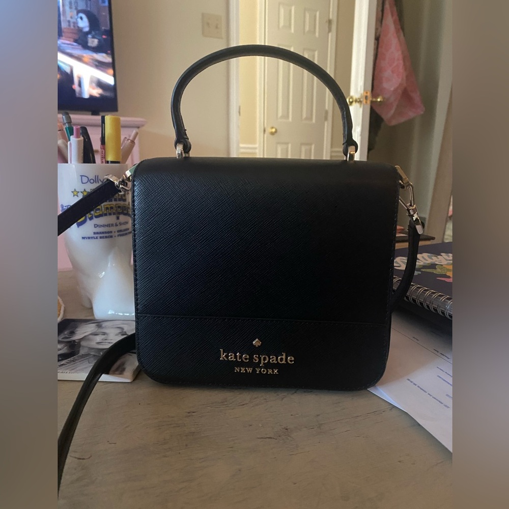 Black Kate spade crossbody bag with detachable and adjustable straps.